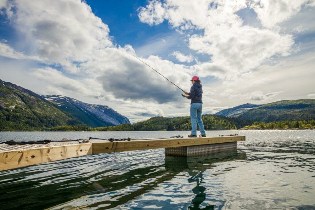 Woman on boat dock with fishing rod